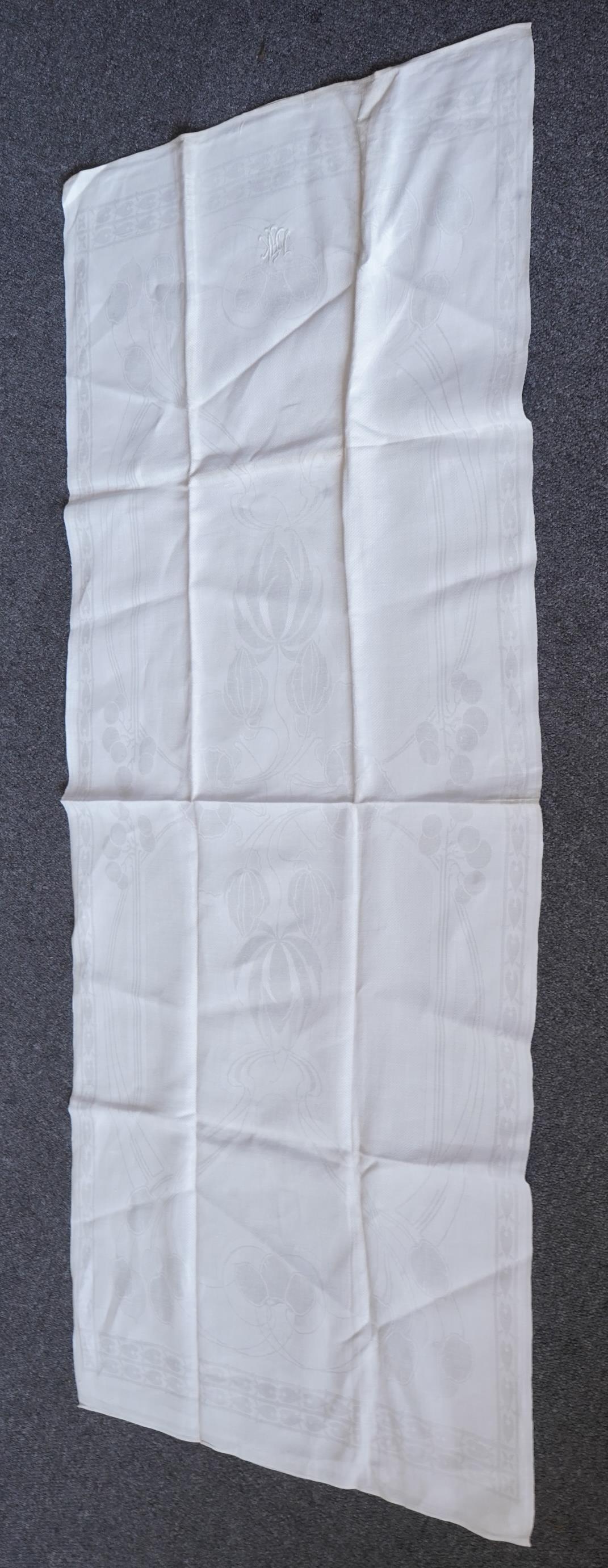 A set of four large Art Nouveau, unused white damask woven hand towels. The pattern having strong Archibald Knox and Walter Crane design elements; with trailing Honesty seeds and Tulip flower heads, these motifs much use